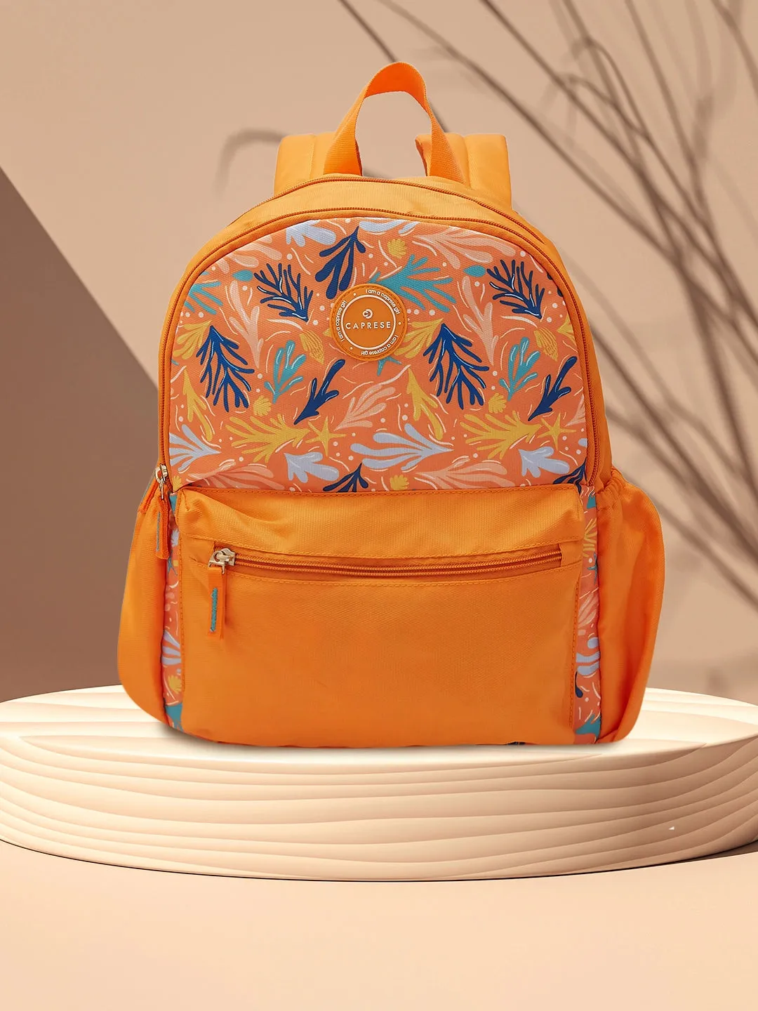 Caprese Xenia Backpack Medium Dual Compartment Orange Printed