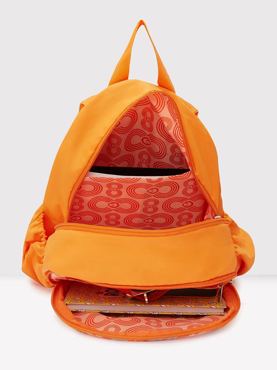 Caprese Xenia Backpack Medium Dual Compartment Orange Printed