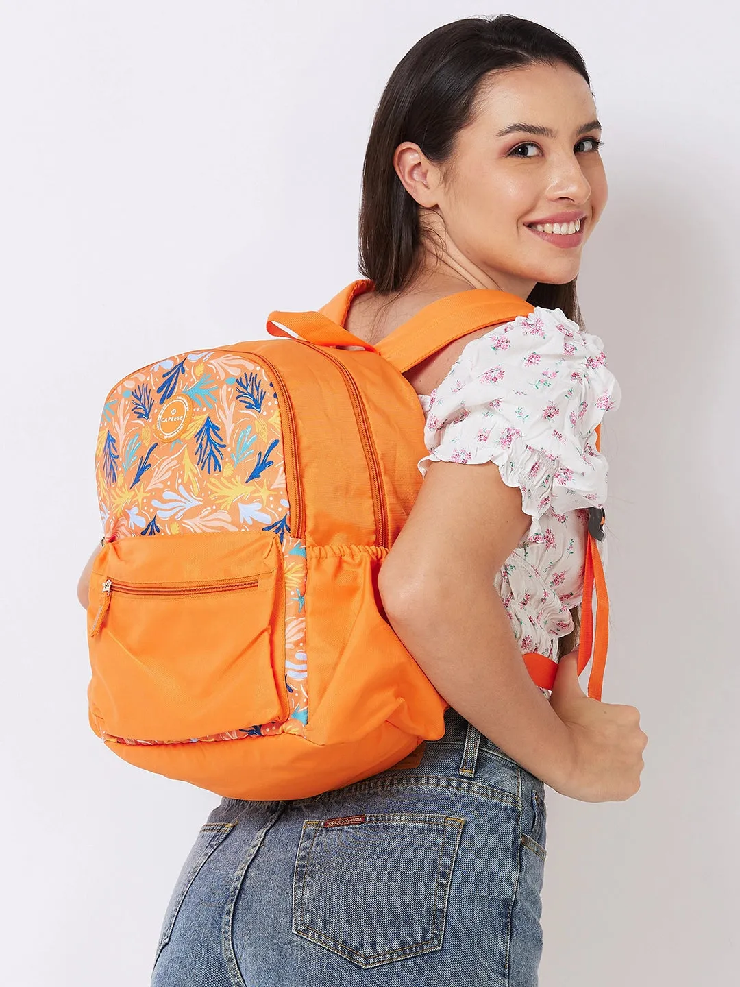 Caprese Xenia Backpack Medium Dual Compartment Orange Printed